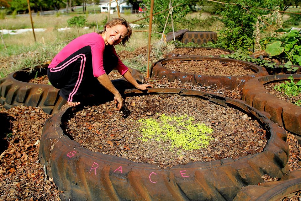 Shellie tends seedlings in the monster truck tire raised beds.
