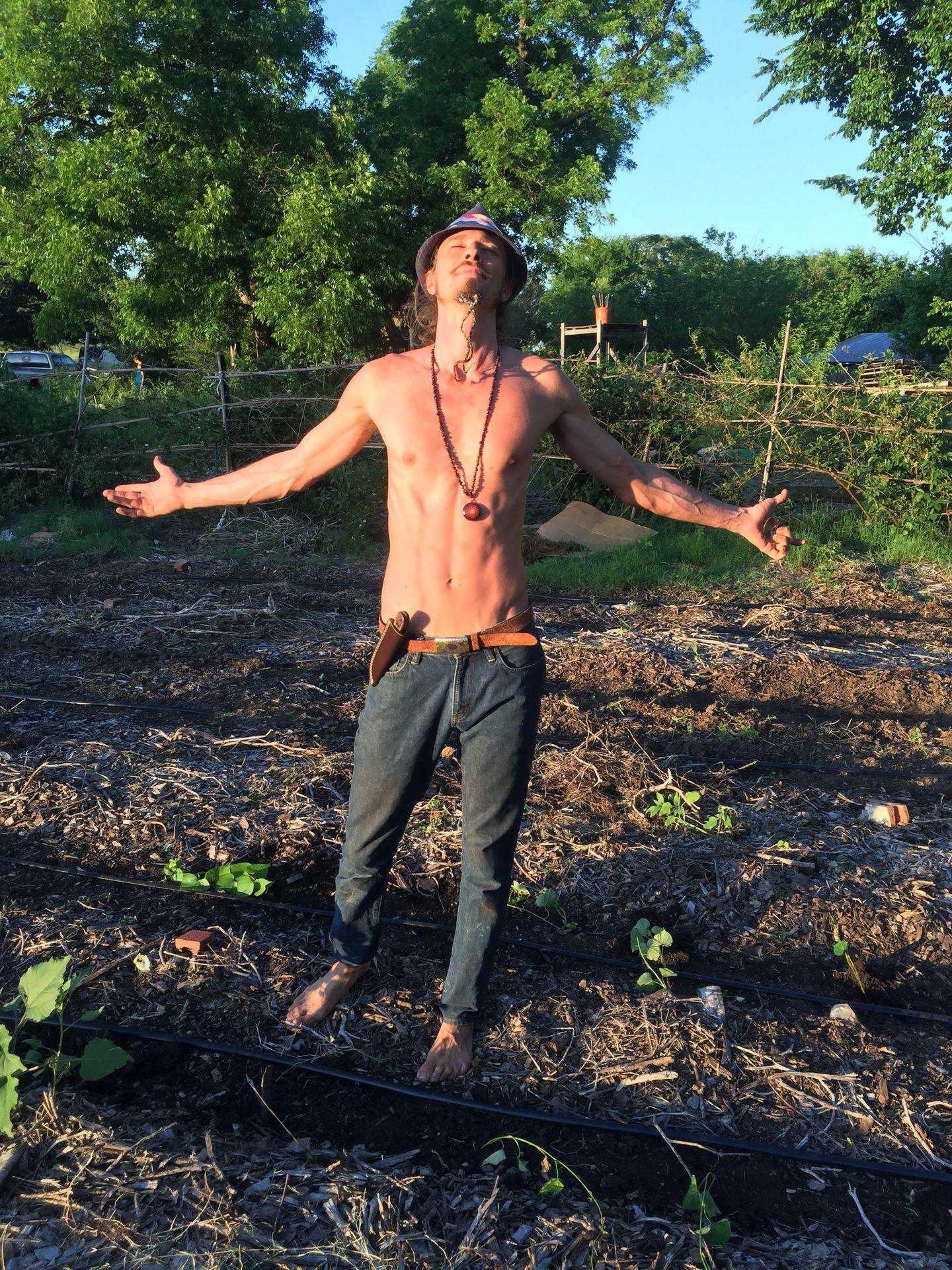 Quinn breathes deeply and blesses the newly planted sweet potato patch