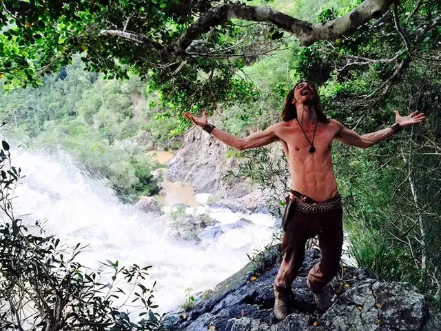 Quinn thriving at a waterfall