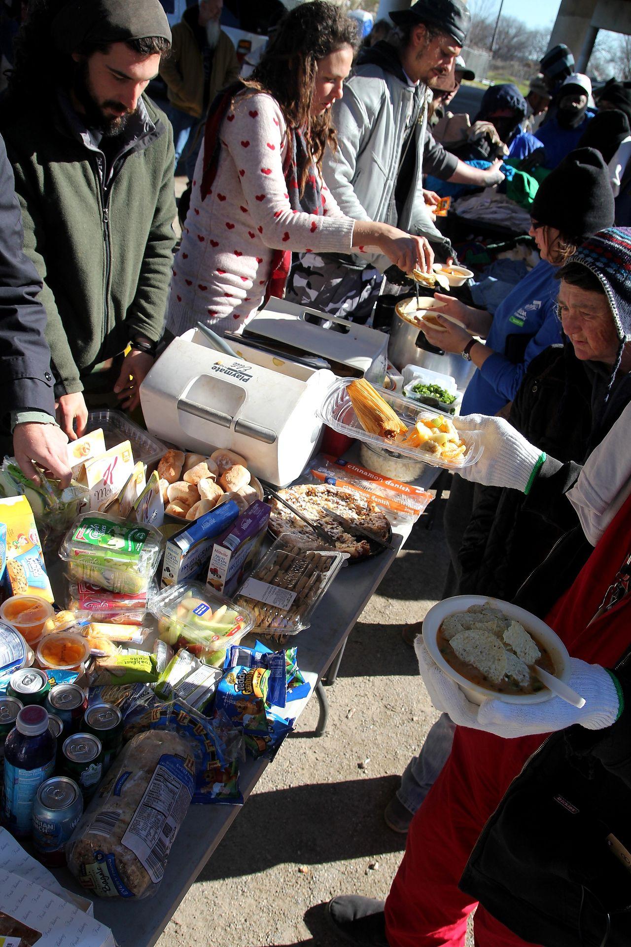 Eden Knights hand out free food to the homeless during The Garden of Eden's Feed the People outreach.