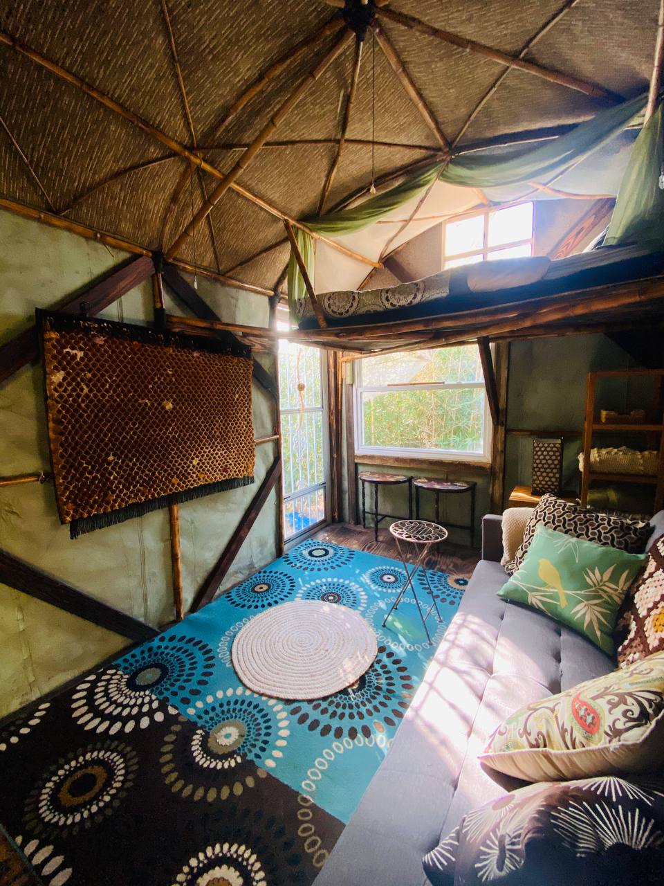The unique interior of the bamboo bungalow has a lofted bed.