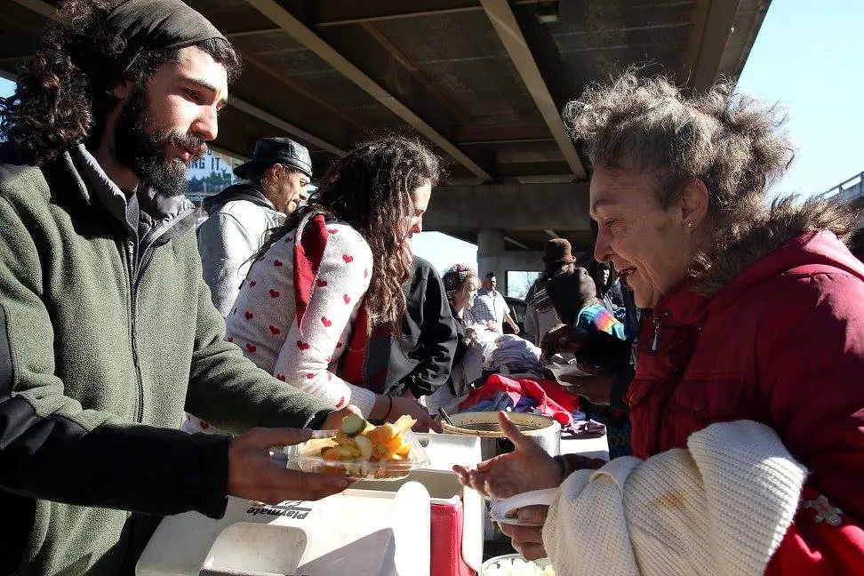 Volunteers from The Garden of Eden feed the homeless in Dallas, TX