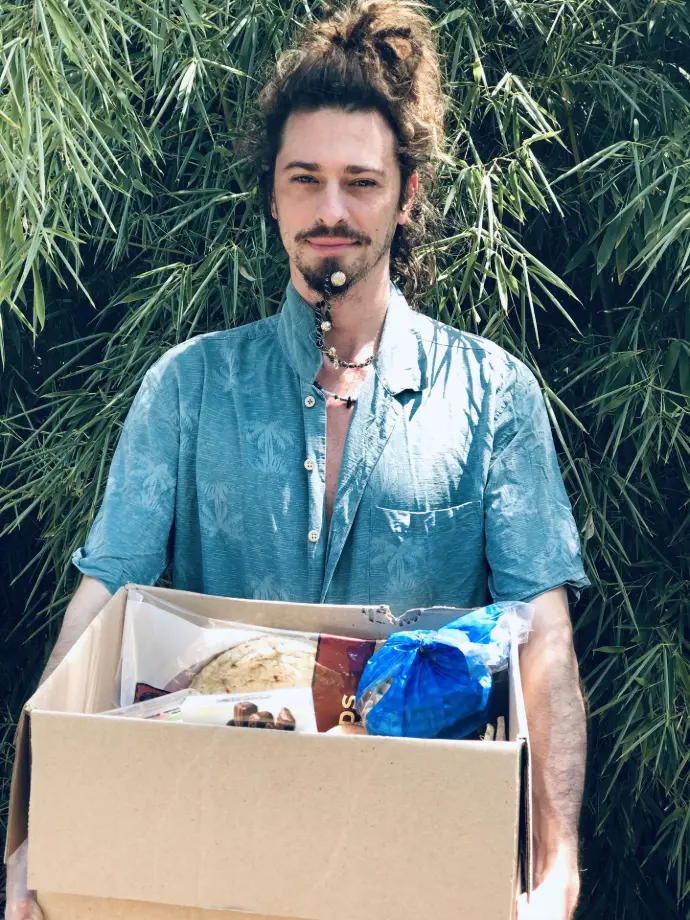 Quinn with a box of food to donate to a hungry family