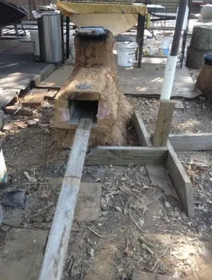 A rocket stove in the outdoor kitchen of The Garden of Eden