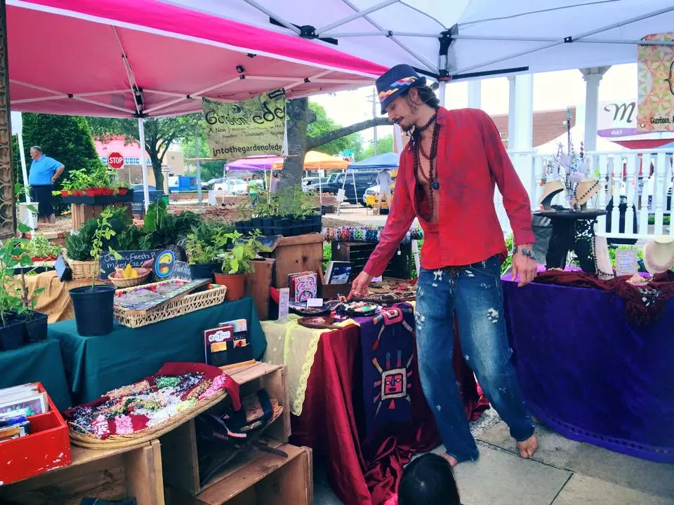 Quinn at The Garden of Eden booth at an outdoor market