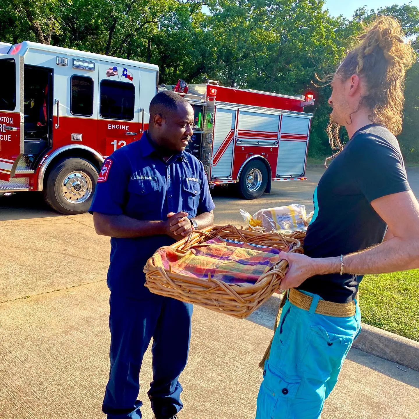 Quinn donates a basket of food to the firemen