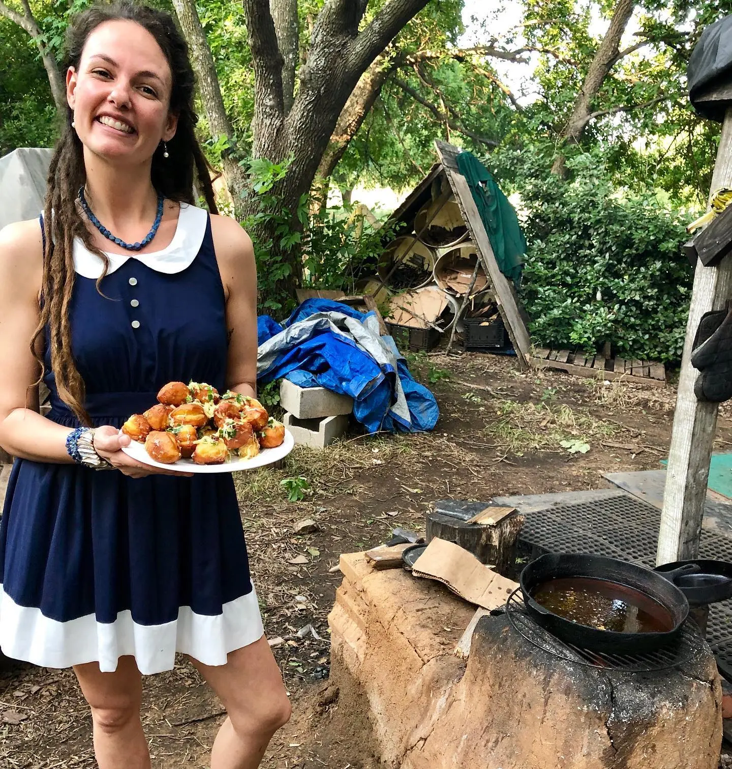 Sara! with the cheesy bread she cooked on the rocket stove in the outdoor kitchen